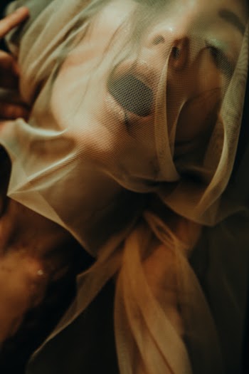 Woman Covering Her Face With Brown Scarf
