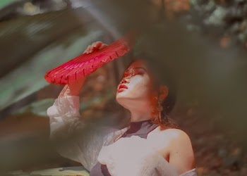 Woman Covering Her Face With Hand Fan