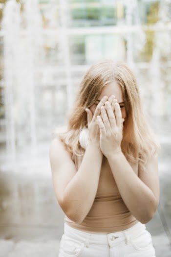 Woman Covering Her Face with Her Hands