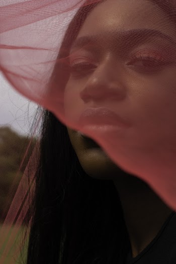 Woman Covering Her Face With Pink Lace Scarf