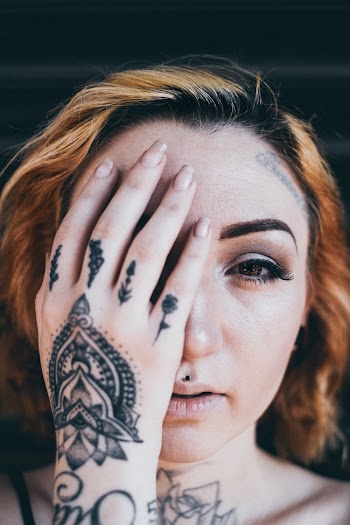 Woman Covering Her Face With Right Hand