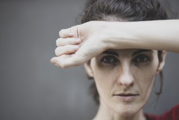Woman Covering Her Forehead
