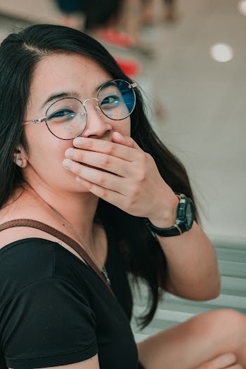 Woman Covering Her Mouth