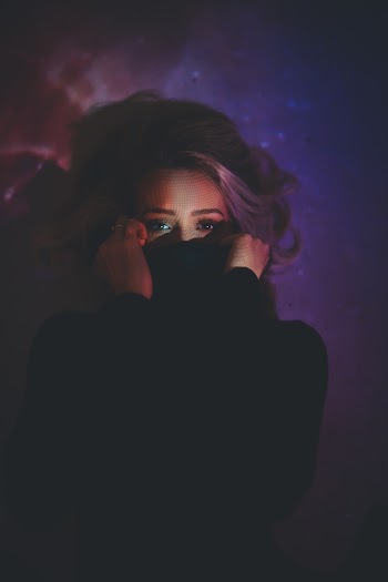 Woman Covering Her Mouth Inside Dark Room