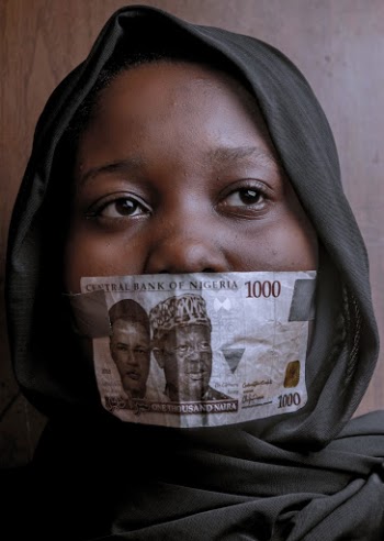 Woman Covering Her Mouth with 1000 Naira Note