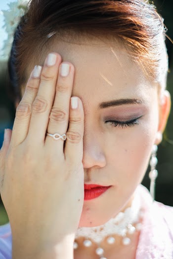 Woman Covering Her Right Eye With Her Right Hand