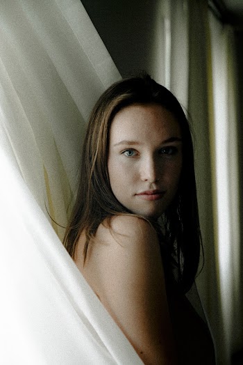 Woman Covering Herself With Curtain