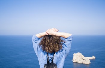 Woman Crossing Her Hands over Her Head
