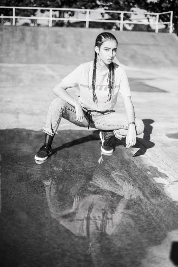 Woman Crouching Near Puddle
