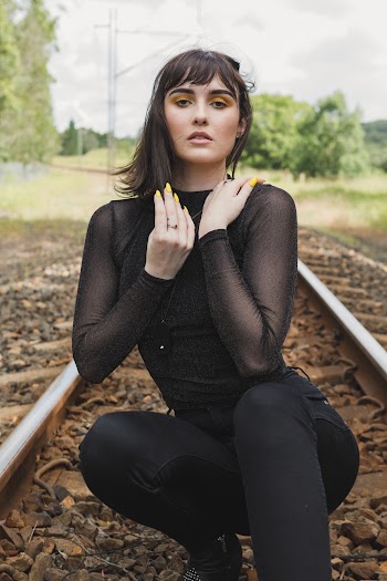Woman Crouching On Train Track