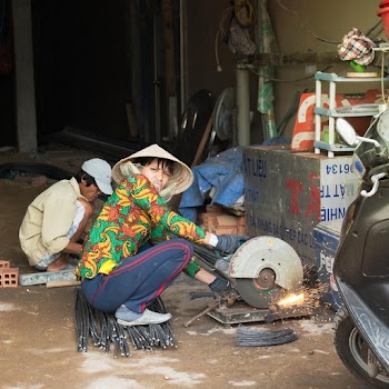Woman Cutting Metal