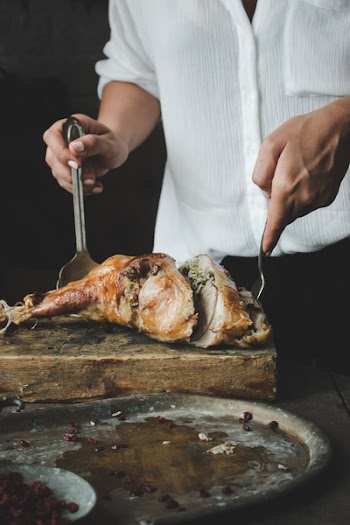 Woman cutting turkey thigh 