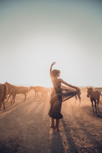Woman Dancing on Field Among Horses · Free Stock Photo