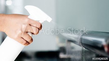Woman disinfecting the railings during coronavirus outbreak