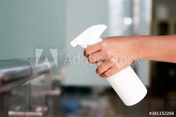 Woman disinfecting the railings during coronavirus outbreak