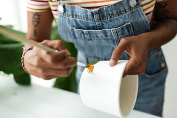 Woman DIY pot painting hobby at home | Free stock photo | High Resolution image