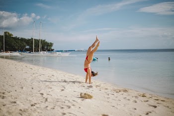 Woman Doing Head Stand on Shoreline