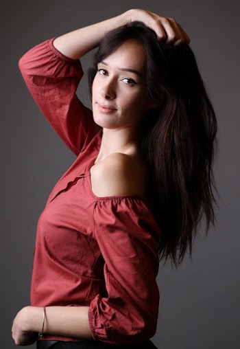 Woman Doing Side View Pose Wearing Red Off-shoulder Shirt