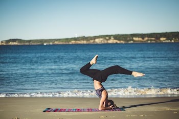 woman doing yoga beside the seashore
