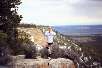 Woman doing yoga on a cliff
