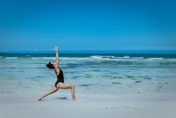 Woman doing yoga on the beach