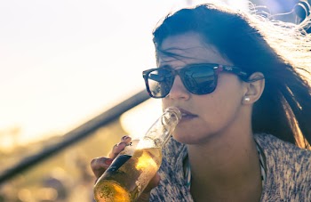 Woman Drinking Beverage on Bottle