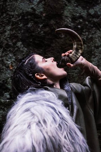 Woman Drinking Water On Animal Horn