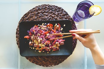 Woman eating beet glass noodles 