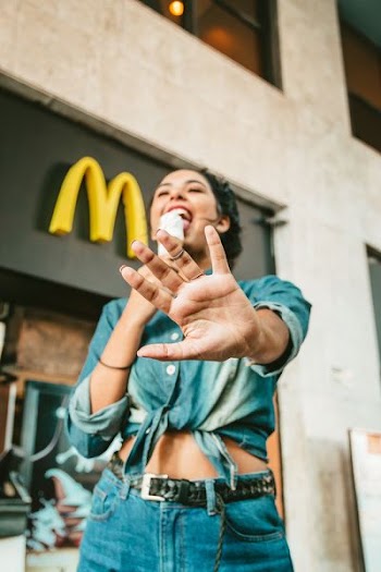 woman eating ice cream near McDonald's