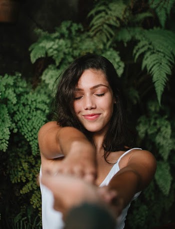Woman Extending Her Arms Towards Person's Hand