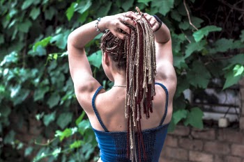 Woman Facing Brown Brick Wall