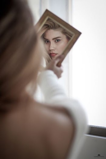 woman facing the mirror
