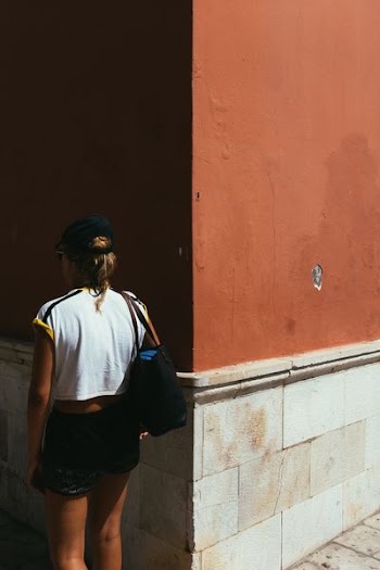 woman facing wall