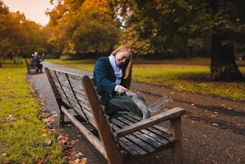 Woman Feeding Brown Squirrel on Bench