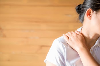 Woman feeling exhausted and suffering from neck pain. Free Photo