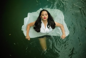 Woman Floating In Body Of Water