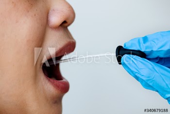 Woman getting a mouth swab to test for coronavirus