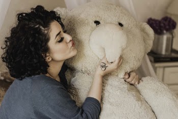 Woman Giving A Kiss To Life Sized Plush Toy