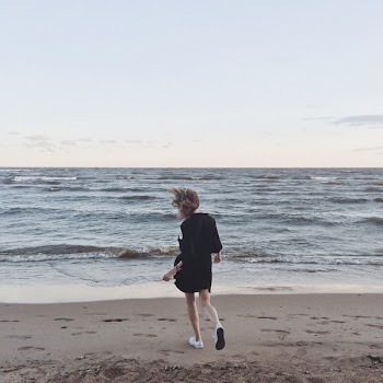 Woman Going Toward the Sea Under Clear Skies