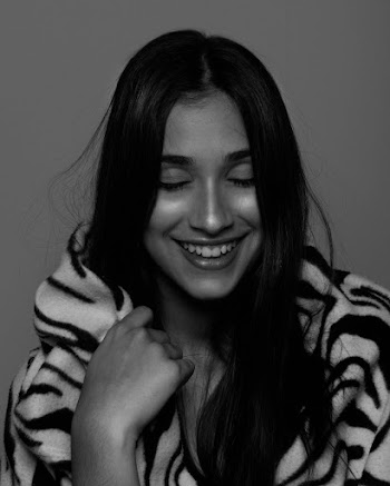 Woman Grinning While Holding Her Zebra Print Scarf
