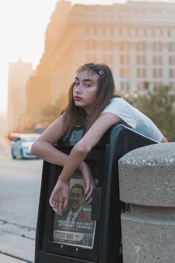 woman hanging on post