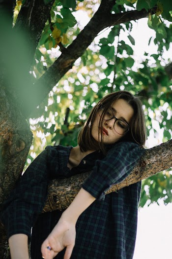 Woman Hanging on  the Tree Branch