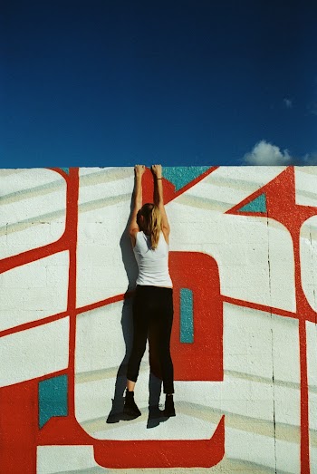 Woman Hanging on Wall