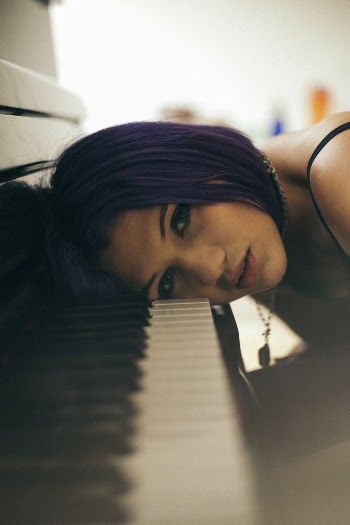 Woman Head Leaning on Piano Keys