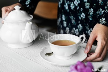 Woman helping herself with a cup of nice hot tea