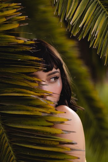 Woman Hiding Behind Leaf