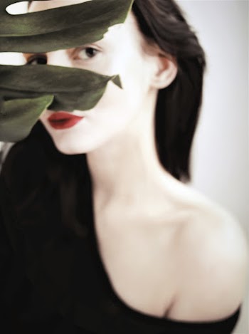 Woman Hiding Behind Plant