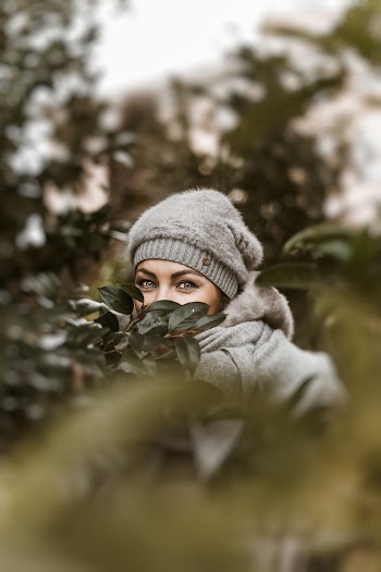 Woman Hiding Behind Plants