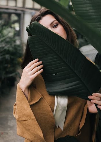 woman hiding behind the leaf