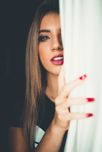 Woman Hiding Behind White Textile